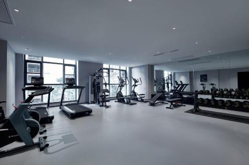 a gym with several treadmills and elliptical machines at 西双版纳熙源国际酒店 in Jinghong