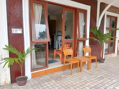 a group of chairs and a table in front of a building at Lippo Carita 9270 in Carita