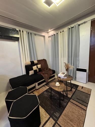 a living room with a couch and a table at Unique Vibes Staycation in Punta
