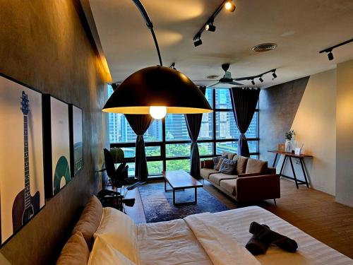 a living room with a bed and a couch at Metro Studio - Direct LRT access, near Pantai Hospital, University Malaya, Mid Valley, Bangsar in Kuala Lumpur