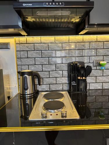 a stove top with a coffee pot on top of it at Unique Vibes Staycation in Punta