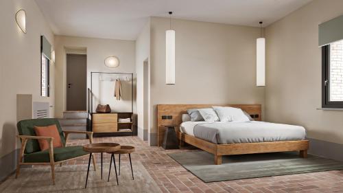 a bedroom with a bed and a chair and a table at The Monteleone Umbria Retreat in Monteleone dʼOrvieto