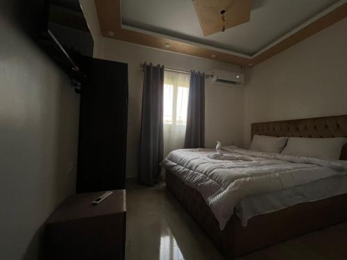 a bedroom with a bed and a window at Aladdin Sphinx & Pyramid Stay in Cairo