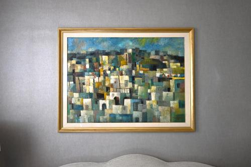 a painting of a city on a wall at The Phoenicia Malta - The Leading Hotels of the World in Valletta