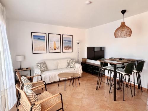 a living room with a couch and a table at Villa Majanicho Pueblo con piscina in Majanicho