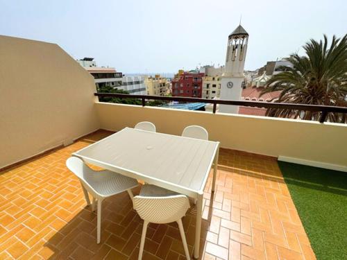 a white table and two chairs on a balcony at Cozy & Terrace Apartament5 in Los Cristianos