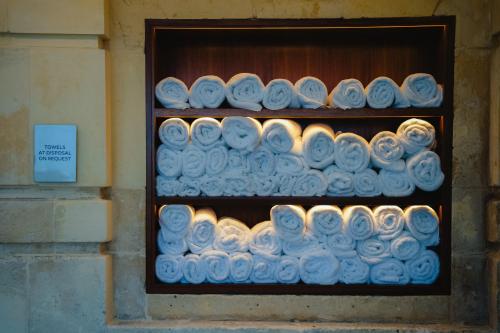 a shelf filled with blue and white cupcakes at The Phoenicia Malta - The Leading Hotels of the World in Valletta
