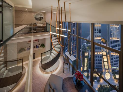 a living room with a view of a city at Ouchen International Sky River Hotel (Monument to the people's Liberation Pedestrian Street Store, Chongqing) in Chongqing