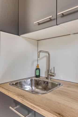 a kitchen sink with a soap bottle on it at Vakantiehuis - Brabantse gezelligheid met sauna VP098 in Hoeven