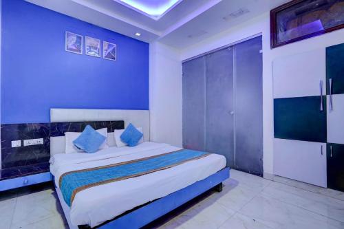 a bedroom with a large bed with blue walls at Hotel Season Couple friendly Rooms Best Hotel Pitampura metro station in New Delhi