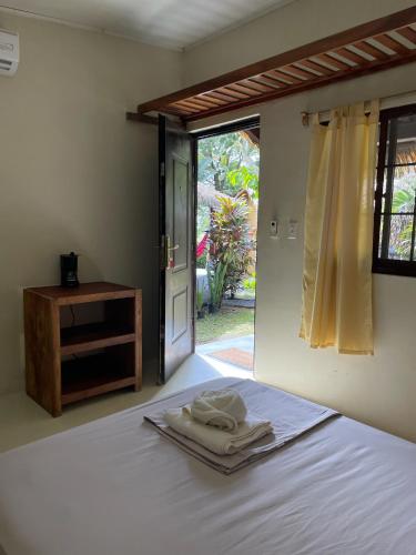 a bedroom with a bed with towels on it at Hotel Las Hamacas in Santa Catalina