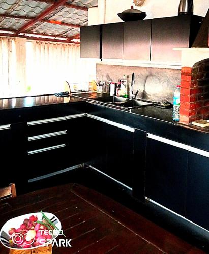 a kitchen with a plate of fruit on a table at Guest house Melissa in Tuléar