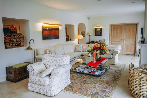 a living room with a couch and two chairs and a table at Chalet La Forestière in Saint-Paul-en-Chablais