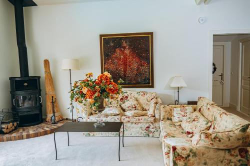 a living room with a couch and a fireplace at Chalet La Forestière in Saint-Paul-en-Chablais