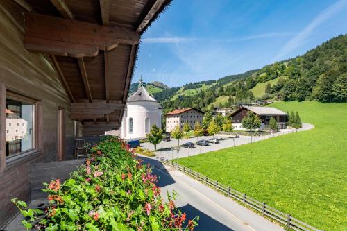 a balcony with a view of a village and a church at Appartements Bucher in Brixen im Thale