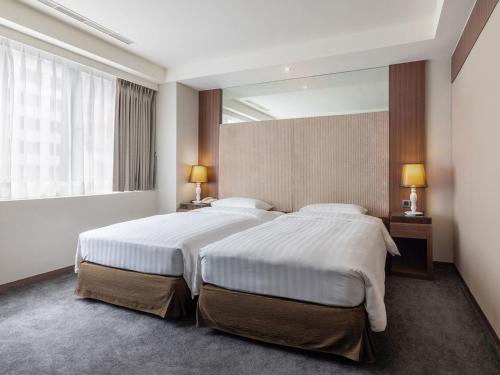 Postel nebo postele na pokoji v ubytování Green World Mai - NanJing