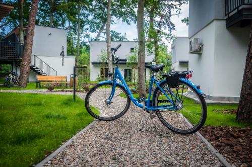 a blue bike parked in front of a house at Baltic Forest in Kołobrzeg