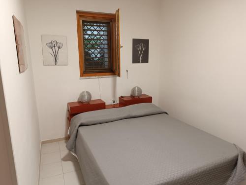 a bedroom with two beds and a window at La Magnolia sul Lago in Campolattaro