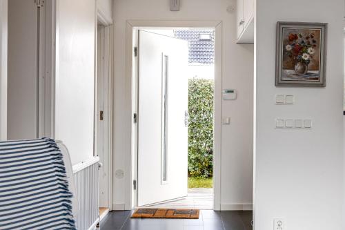 a hallway with a door leading to a yard at Cozy House near Beach, City & Activities in Falkenberg