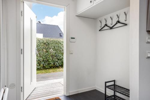 a hallway with a door leading into a house at Cozy House near Beach, City & Activities in Falkenberg