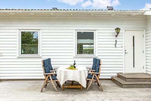 a table and two chairs on a patio at Cozy House near Beach, City & Activities in Falkenberg