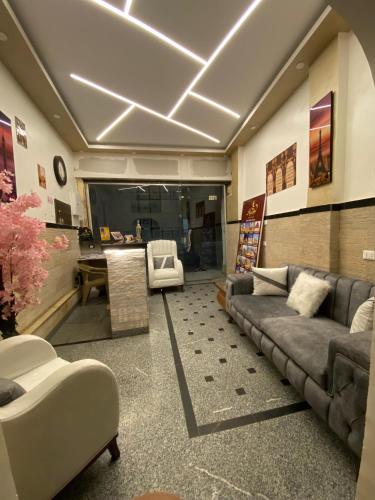a living room with a couch and a table at Aladdin Sphinx & Pyramid Stay in Cairo