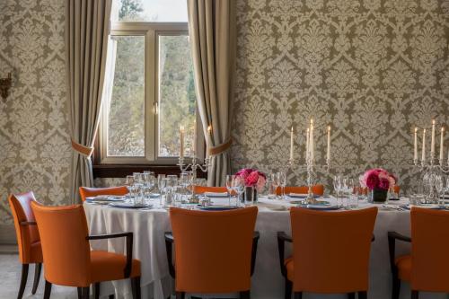 a dining room with a table and chairs and a window at The Phoenicia Malta - The Leading Hotels of the World in Valletta