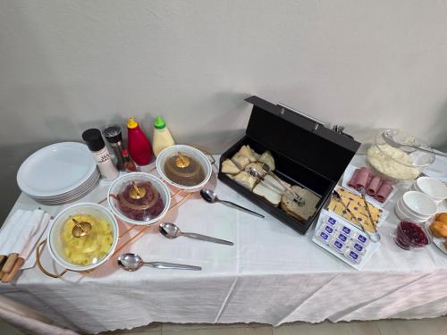 a table with a buffet of food on it at White Garden Hotel in Maputo