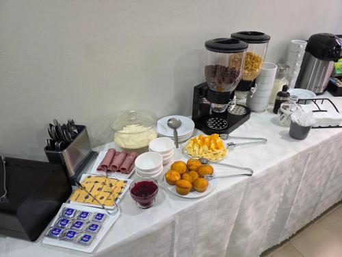 a table with a buffet of food on it at White Garden Hotel in Maputo