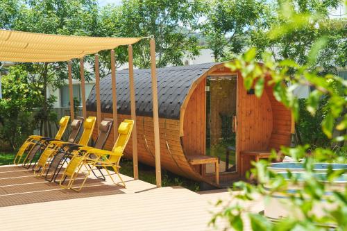 a group of chairs sitting in front of a cabin at BEB5 Okinawa Seragaki by Hoshino Resorts in Onna