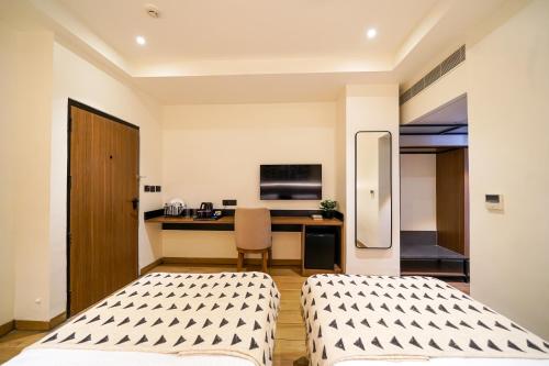 Ένα ή περισσότερα κρεβάτια σε δωμάτιο στο Olive Hotel Benz Circle, Vijayawada by Embassy Group