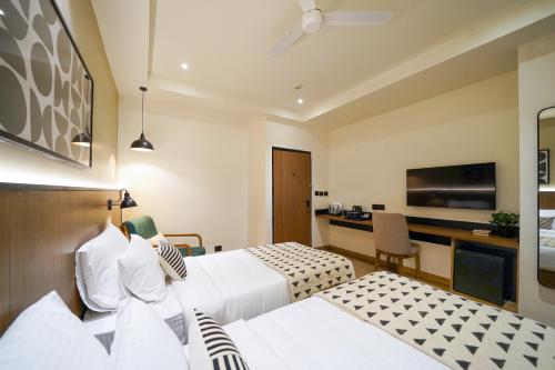 Ένα ή περισσότερα κρεβάτια σε δωμάτιο στο Olive Hotel Benz Circle, Vijayawada by Embassy Group