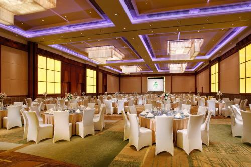 a large banquet hall with white tables and chairs at Holiday Inn Shanghai Pudong Kangqiao by IHG - Free shuttle bus to Disney land, Ins Swimming Pool in Shanghai