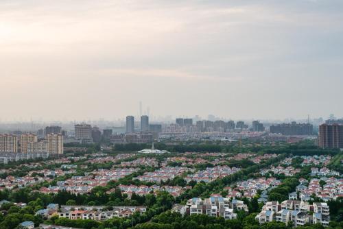 an aerial view of a city with buildings at Holiday Inn Shanghai Pudong Kangqiao by IHG - Free shuttle bus to Disney land, Ins Swimming Pool in Shanghai