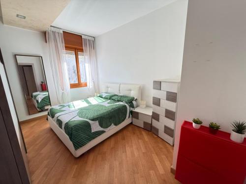 a small bedroom with a bed and a mirror at The Kaktus House - vicino San siro e Rho Fiera in Milan