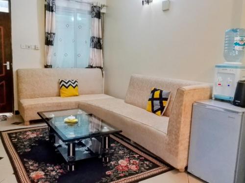 Una sala de estar con un sofá y una mesa de café. en Shanzu Gem, en Mombasa