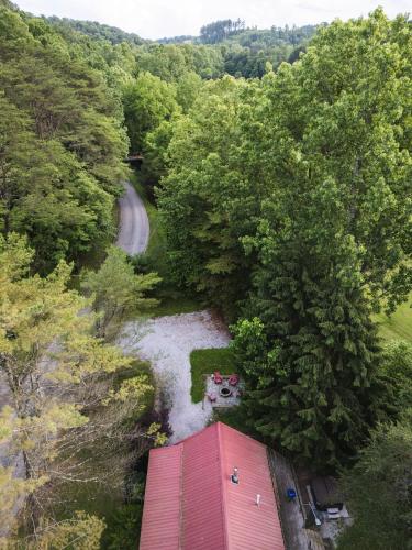 an aerial view of a red barn and a road at Little Redwood - Hocking Hills, Hot Tub & Games in Logan