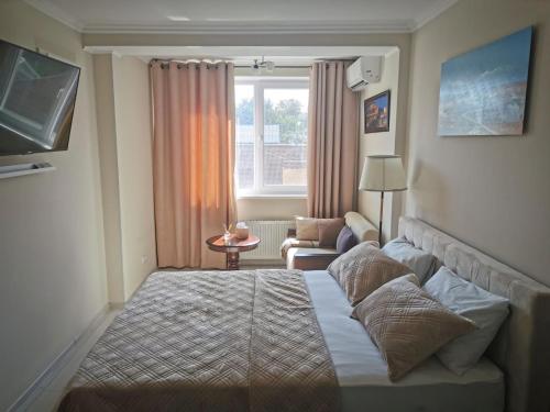 a hotel room with a bed and a window at 1 and 2 bedrooms city center rentals in Chişinău