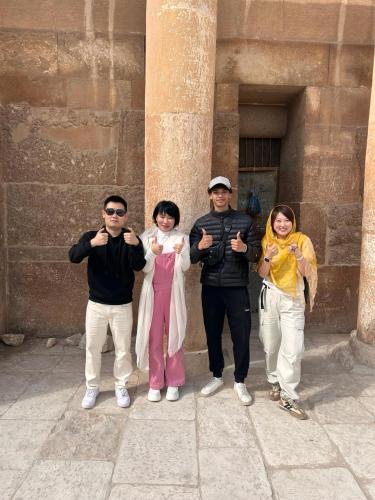 a group of people standing in front of a building at Aladdin Sphinx & Pyramid Stay in Cairo