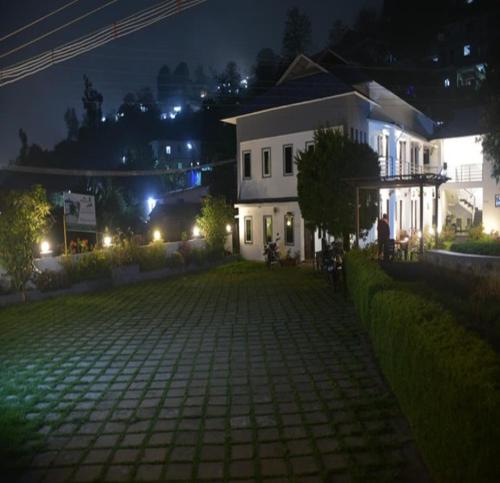 a house at night with a cobblestone yard at Magizham Homestay in Kodaikānāl