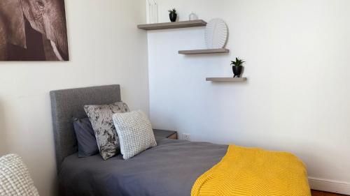 a bedroom with a bed with two plants on the wall at Obs Centre The Lookout in Cape Town