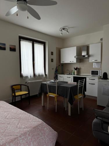 a kitchen and dining room with a table and chairs at Landscapesilvia PT Terra in Menaggio