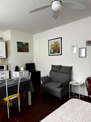 a living room with a couch and a table at Landscapesilvia PT Terra in Menaggio