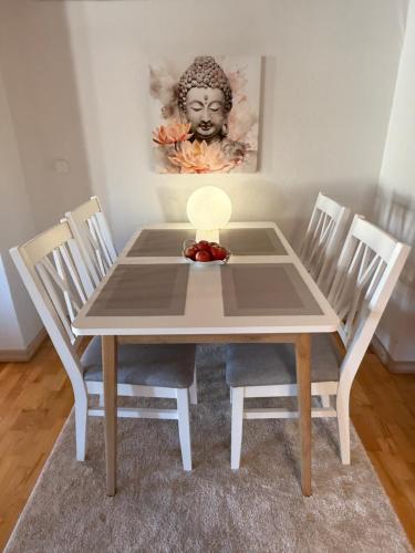 a table with chairs and a plate of fruit on it at Villa 16 in Kivik