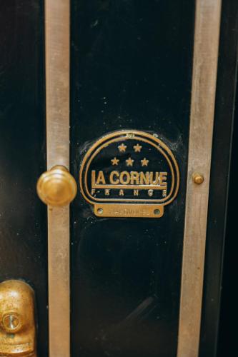 a black door with a gold sign on it at Chalet La Forestière in Saint-Paul-en-Chablais