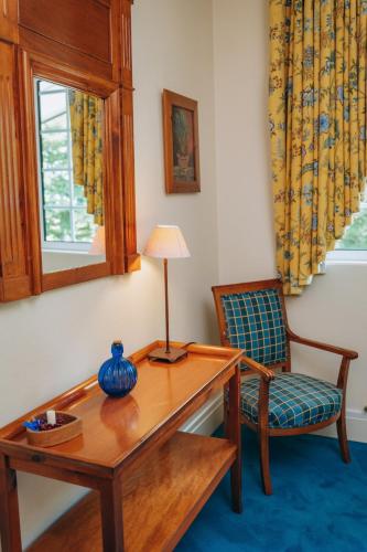 a living room with a table and a chair at Chalet La Forestière in Saint-Paul-en-Chablais