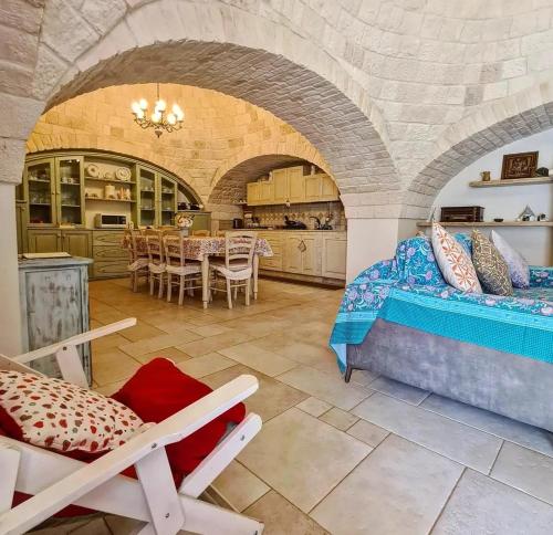 a room with a bed and a table and chairs at Trulli Pax Animi in Martina Franca