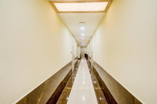 a long corridor in a building with a ceiling at Townhouse OAK Seventy Seven in Dum Dum