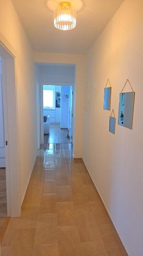 a living room with a hallway with a table and chairs at Golden Sky in Cazin