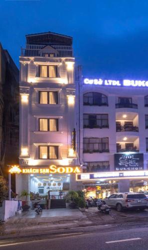 a white building with a sign on the front of it at Soda Hotel Đà Lạt in Da Lat
